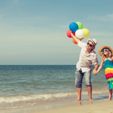 Father walking with his daughter on a beach