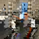 Boy in a wheelchair in an accessible toilet