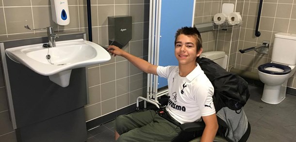 Boy in a wheelchair in an accessible toilet