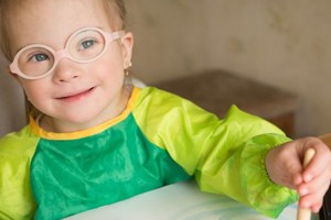 A child smiling while painting