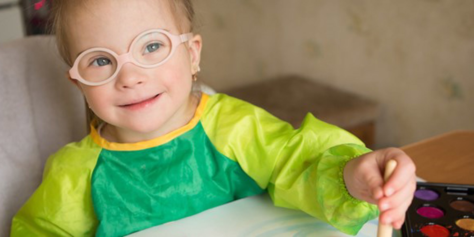 A child smiling while painting
