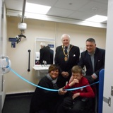 cutting the ribbon to open the changing places facility with people and mayor in the background