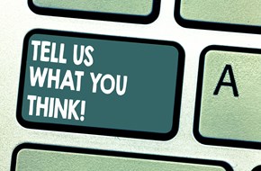 Close up of a keyboard button with the words 'Tell us what you think!' on it