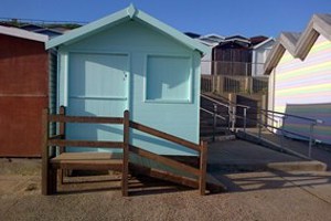 A photo of a blue beach hut