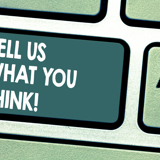 Close up of a keyboard button with the words 'Tell us what you think!' on it