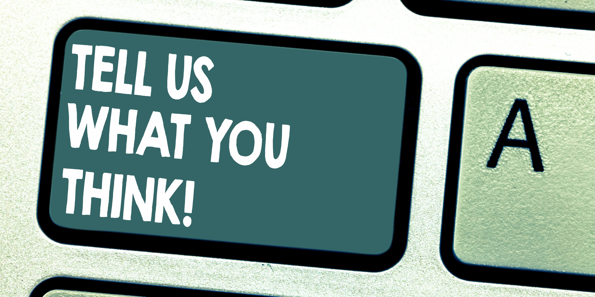Close up of a keyboard button with the words 'Tell us what you think!' on it
