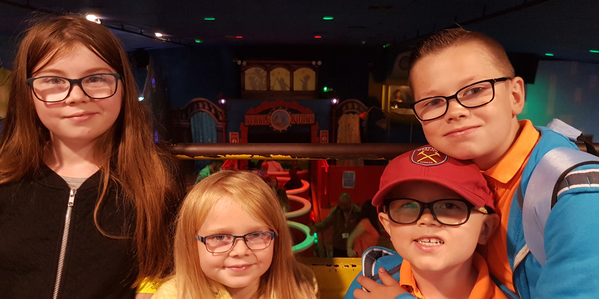 Four young children wearing glasses looking at the camera
